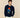 Man wearing a navy blue sweater with a Paddington Bear design.