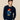 Man wearing a navy blue sweater with a Paddington Bear design.