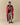 A man standing while wrapped in a cozy, red and white Sheep Sherpa Throw Blanket Diana Red with a sheep motif.