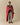 A person wrapped in a cozy, red and white Sheep Sherpa Throw Blanket Diana Red featuring a sheep pattern.