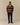 A model wears a Rowing Blazers Fair Isle Clark Sherpa Multi-Color pullover with a yellow collar, navy corduroy trousers, and brown boat shoes.