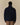 A person seen from the back wearing a navy blue Clark Sherpa Navy pullover with a purple inner collar and hem.