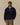 A Rowing Blazers Clark Sherpa Navy pullover in navy blue featuring a purple-lined snap-button collar and zippered side pockets.