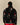Back view of a person wearing a black Rowing Blazers x Paddington™ Tuxedo Paddington Classic Sherpa Black jacket with a repeating pattern of cartoon bears wearing red hats.