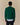 Back view of a person wearing a green Babar Jardinier Cashmere Sweater over a light blue button-down shirt.