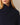 A person wears an oversized navy blue ribbed Kaia Shawl Sweater Navy with a shawl collar.