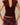 Fitted burgundy Paige U-Neck Corduroy Top with cap sleeves and a deep U-neckline, worn with a plaid skirt.